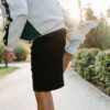 Close-up of a person stretching leg in a sunny outdoor park, ideal for fitness themes.