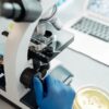 Researcher analyzing biological samples under a microscope in a laboratory.