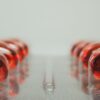 Macro shot of red capsules in a blister pack with selective focus on medicinal pills.