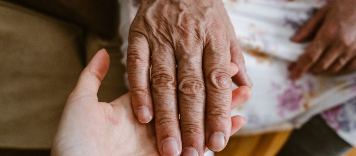 Close-up of elderly and young hands showing care and connection in Türkiye.