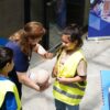 Kids and instructor learning CPR techniques during first aid safety training.