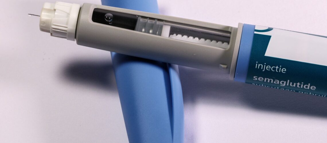 Detailed view of a semaglutide injection pen, commonly used for diabetes treatment, on a plain background.