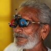 Close-up of a senior man's facial features during an eye examination using specialized equipment.