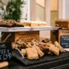 Assortment of vegan and gluten-free cakes on display at a cafe. Perfect for indulgence.