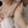 Close-up of elderly women's hands expressing love and connection, symbolizing intimacy and warmth.