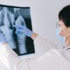 Medical professional reviewing an X-ray, emphasizing healthcare diagnosis and examination.
