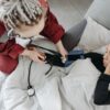Paramedic measuring patient's blood pressure indoors, illustrating home healthcare assistance.