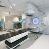 High-tech radiotherapy machine in a hospital's clinical setting for patient treatment.