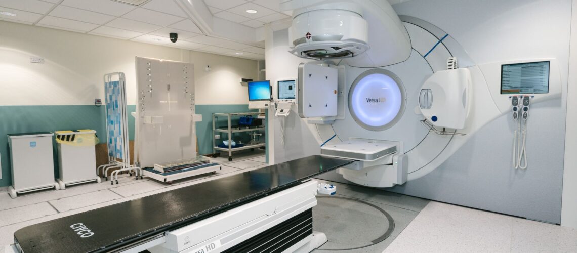 High-tech radiotherapy machine in a hospital's clinical setting for patient treatment.