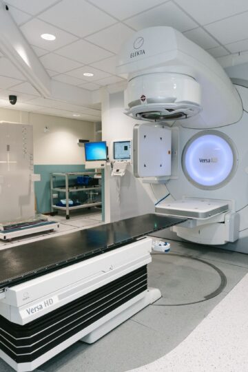 High-tech radiotherapy machine in a hospital's clinical setting for patient treatment.