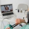 A healthcare professional video conferencing with a patient for an online consultation.