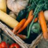 A close-up of fresh organic vegetables in a wicker basket, perfect for healthy eating.