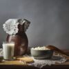 Rustic dairy still life featuring milk, cottage cheese, and bread on a wooden table.