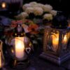 Lanterns with candles illuminate a cemetery on All Saints' Day.