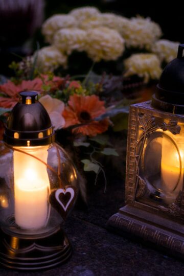 Lanterns with candles illuminate a cemetery on All Saints' Day.