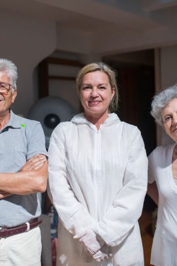 Group portrait of caregivers with senior adults in a home setting.