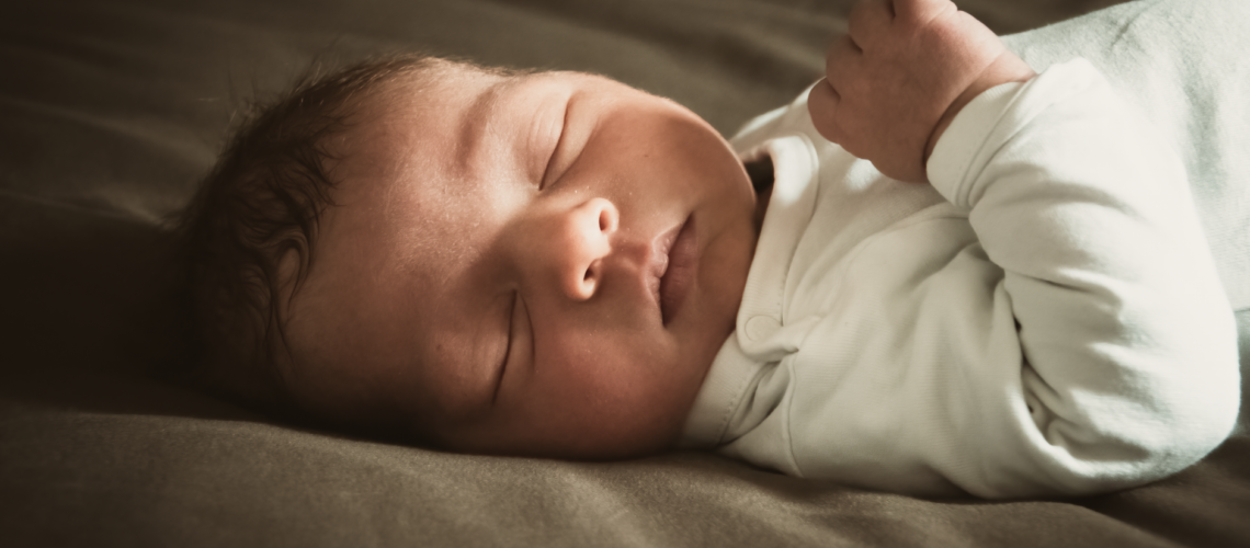 Close-up of a newborn sleeping peacefully indoors with soft lighting. Ideal for lifestyle and family themes.
