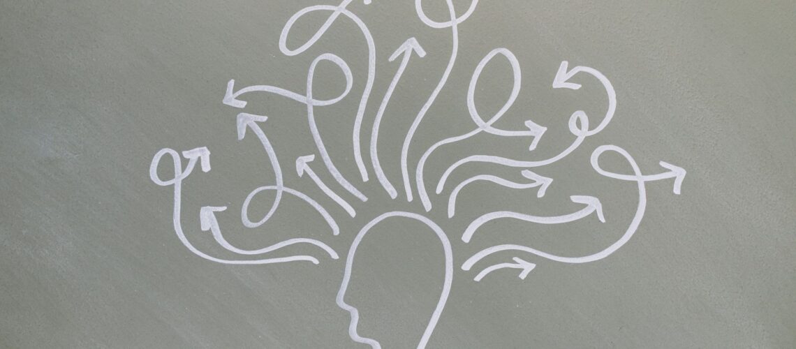 Conceptual chalk drawing illustrating mental health challenges with arrows representing thoughts.