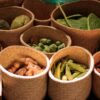 Colorful baskets of fresh vegetables at a Mexican market showcasing a variety of produce.