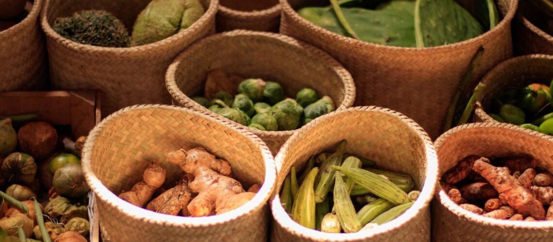 Colorful baskets of fresh vegetables at a Mexican market showcasing a variety of produce.