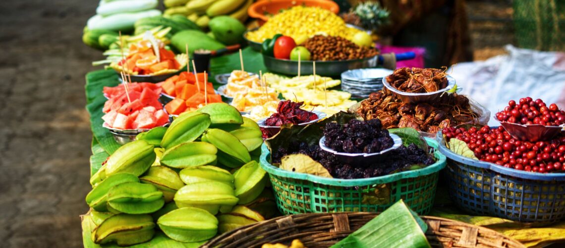 Colorful assortment of fresh fruits displayed for sale at a market stall.