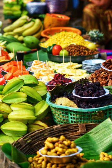 Colorful assortment of fresh fruits displayed for sale at a market stall.