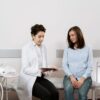 A pregnant woman consulting with a gynecologist in a medical facility.