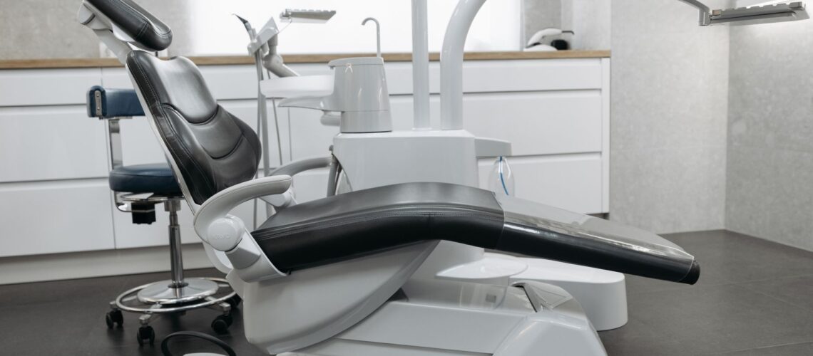 A contemporary dental office with a sleek dental chair and equipment, perfect for healthcare themed needs.