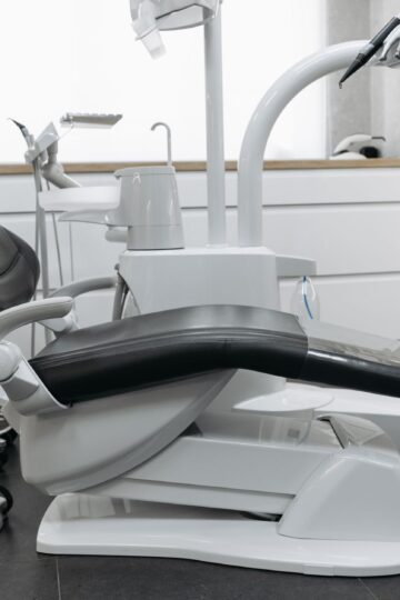 A contemporary dental office with a sleek dental chair and equipment, perfect for healthcare themed needs.