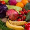 A variety of fresh fruits and vegetables arranged beautifully on a wooden table, showcasing natural nutrition.