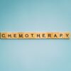 Scrabble tiles spelling 'Chemotherapy' on a blue background, symbolizing medical treatment.