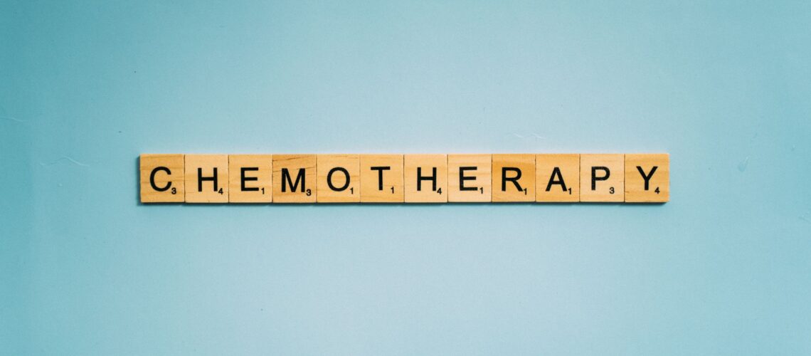 Scrabble tiles spelling 'Chemotherapy' on a blue background, symbolizing medical treatment.