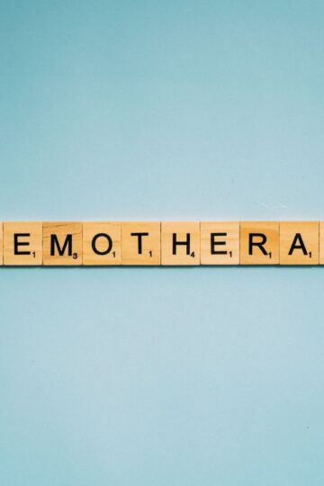 Scrabble tiles spelling 'Chemotherapy' on a blue background, symbolizing medical treatment.