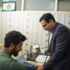 A doctor uses a stethoscope for a patient's health check-up in a clinic.