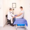Doctor checking patient's vitals in a clinical setting for health consultation.