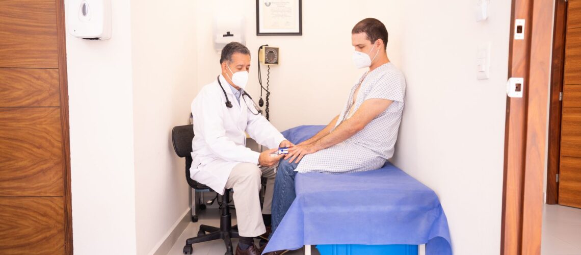 Doctor checking patient's vitals in a clinical setting for health consultation.