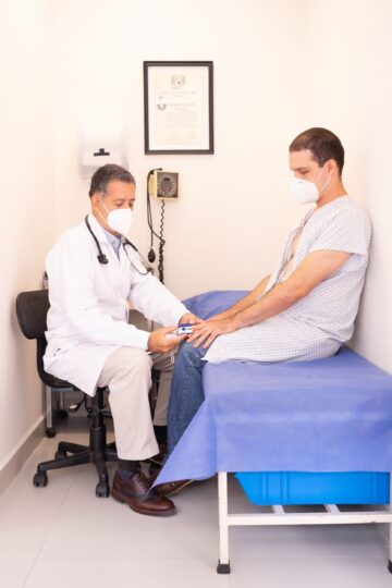 Doctor checking patient's vitals in a clinical setting for health consultation.