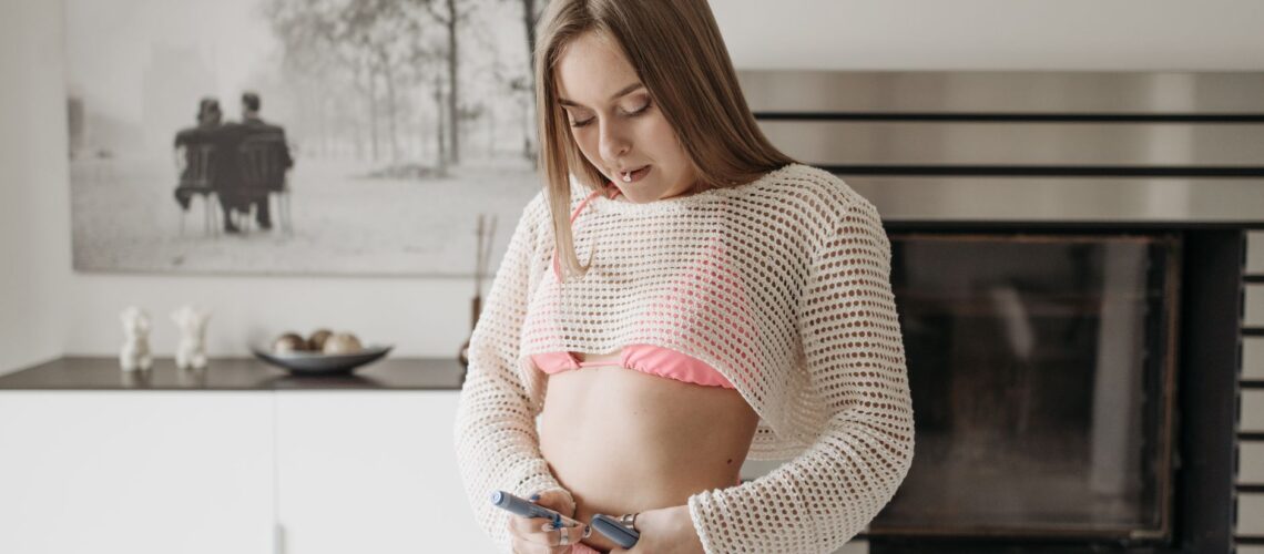 A young woman administers an insulin injection at home, highlighting diabetes care.