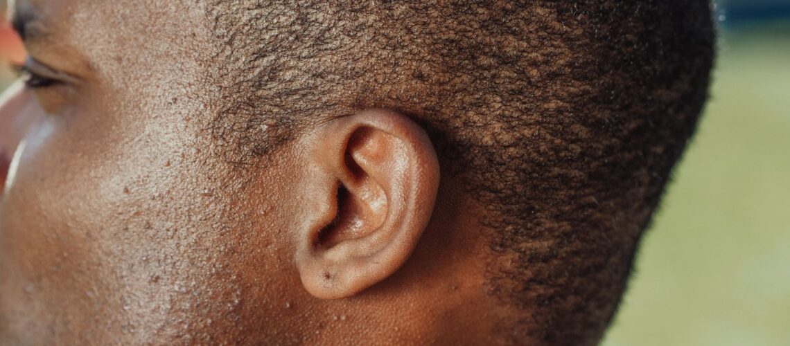 Detailed close-up of a person's ear showcasing skin texture and hair.