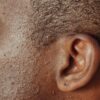 Detailed close-up image highlighting the texture of human skin and ear.
