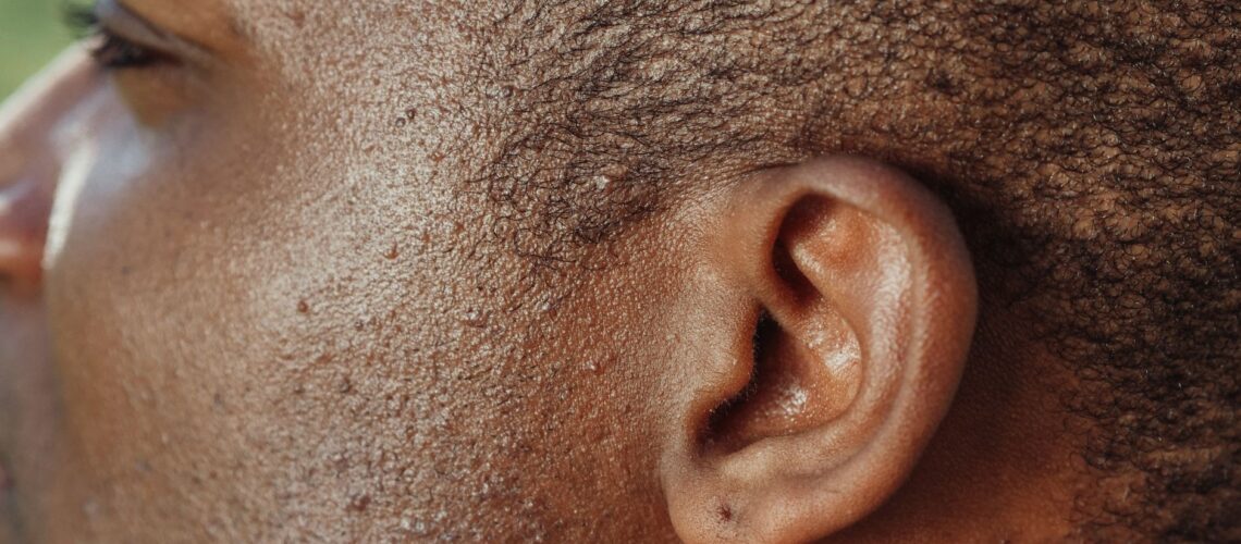 Detailed close-up image highlighting the texture of human skin and ear.