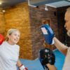 Senior couple practicing boxing indoors for fitness and fun. Emphasizing healthy senior lifestyle.