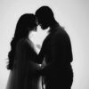 Silhouette of a couple embracing with a backlit glow, symbolizing love and intimacy.