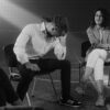 A therapy session with people discussing mental health in a supportive environment.
