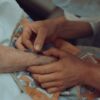 A healthcare professional administers an injection to an elderly patient in a hospital setting.