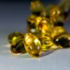Vibrant close-up of golden softgel capsules, perfect for health-related content.
