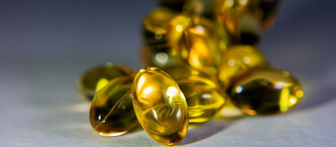Vibrant close-up of golden softgel capsules, perfect for health-related content.