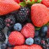 A vibrant close-up of fresh strawberries, raspberries, blackberries, and blueberries.