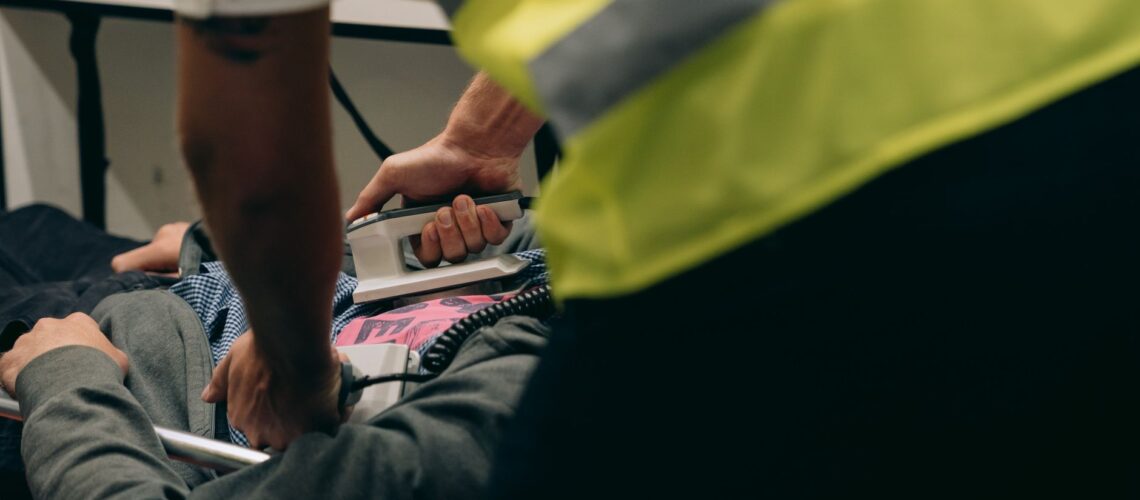 Paramedics provide urgent care to a patient on a stretcher during an emergency situation.