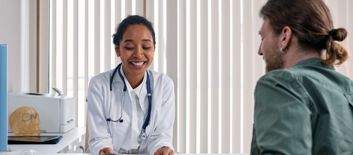 A doctor and patient engaging in a positive consultation in a bright clinic setting.